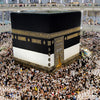 A large crowd of people surrounds a canvas wall art print depicting the Kaaba and Al Masjid An Nabawi.
