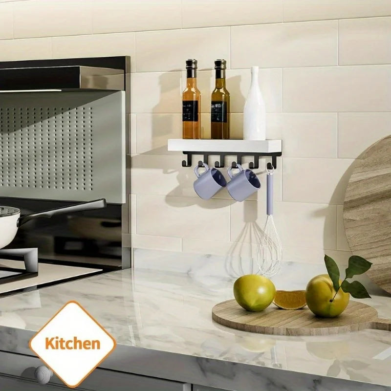 A rustic wooden floating shelf with hooks displaying bottles and a white vinegar bottle on a kitchen backsplash.