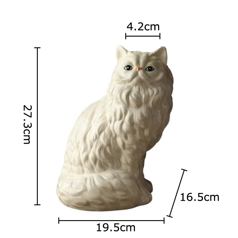 A light beige ceramic cat figurine with large eyes, shown in a side profile.