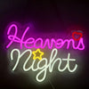 Pink and white neon sign spelling out Heavens Night with a red heart accent.