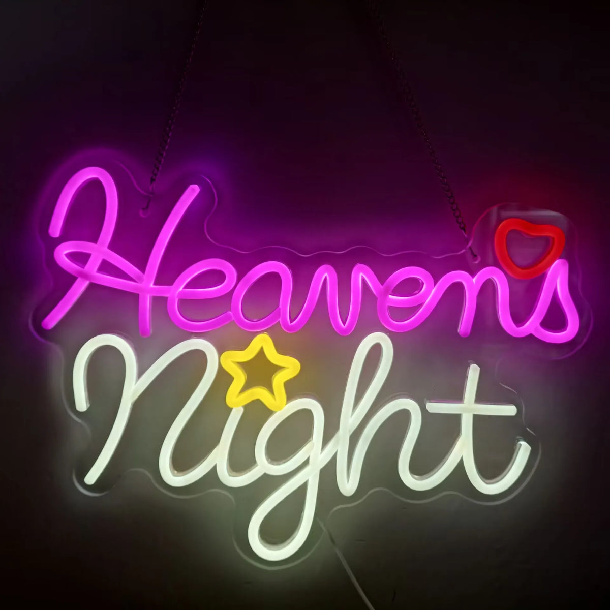 Pink and white neon sign spelling out Heavens Night with a red heart accent.