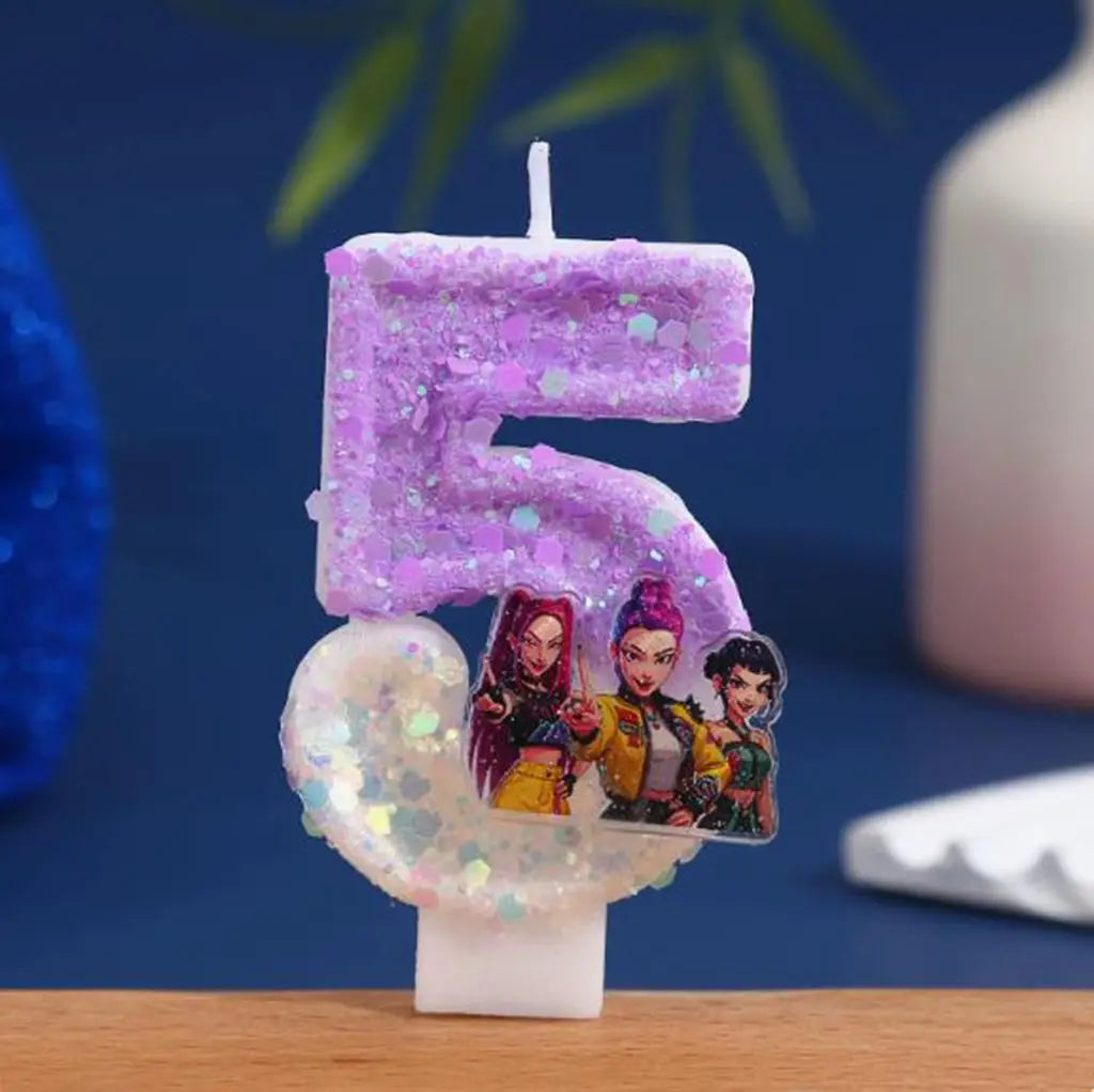 A purple glitter candle shaped like the number 5 featuring three small cartoon figures.