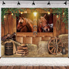 A rustic backdrop featuring two horses framed by greenery and a wooden barn door with rustic decor.