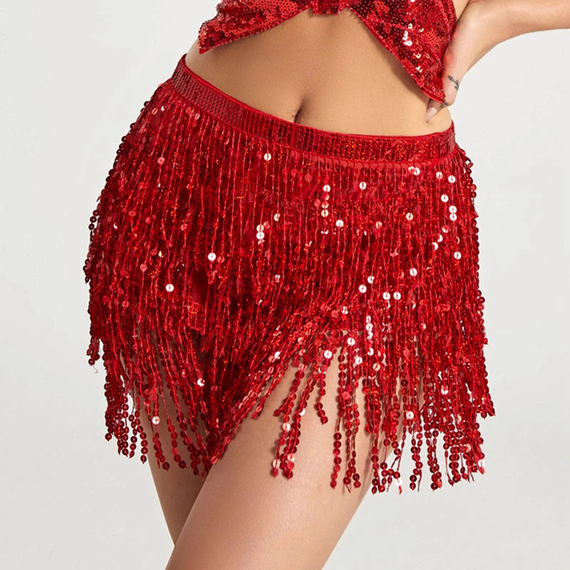 A woman wearing a red sequin hula dancer skirt with tassel belts.