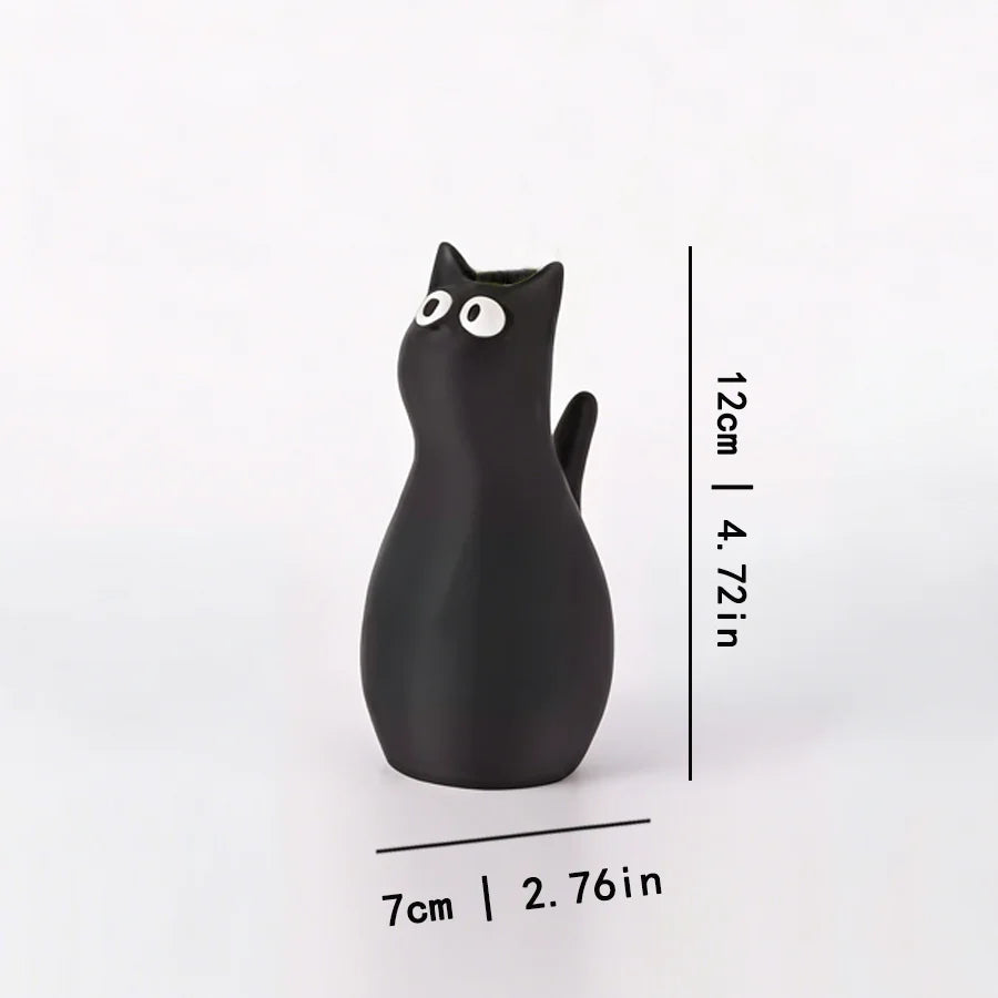 A black cat-shaped table vase with a playful design shown against a white background.