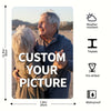 A man and a woman smiling while looking at a custom photo metal sign with weather resistant and waterproof features.