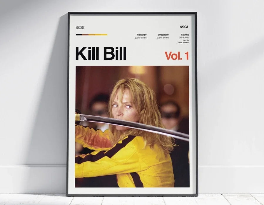 A framed poster for Kill Bill Vol. 1 featuring a close-up of a woman with blonde hair and intense expression.