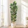 A realistic artificial fiddle leaf fig tree in a white pot standing indoors next to a window.