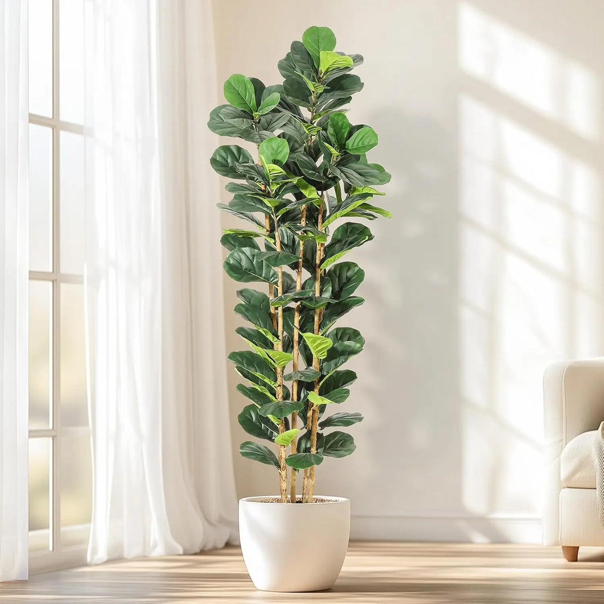 A realistic artificial fiddle leaf fig tree in a white pot standing indoors next to a window.