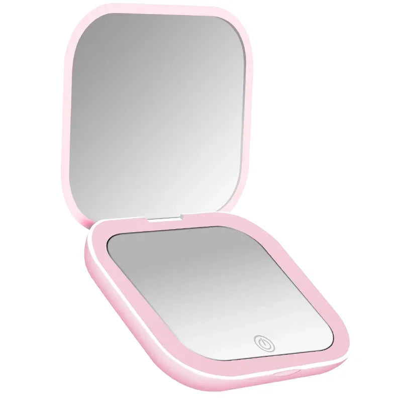 A pink compact portable vanity mirror with a rectangular reflective surface.