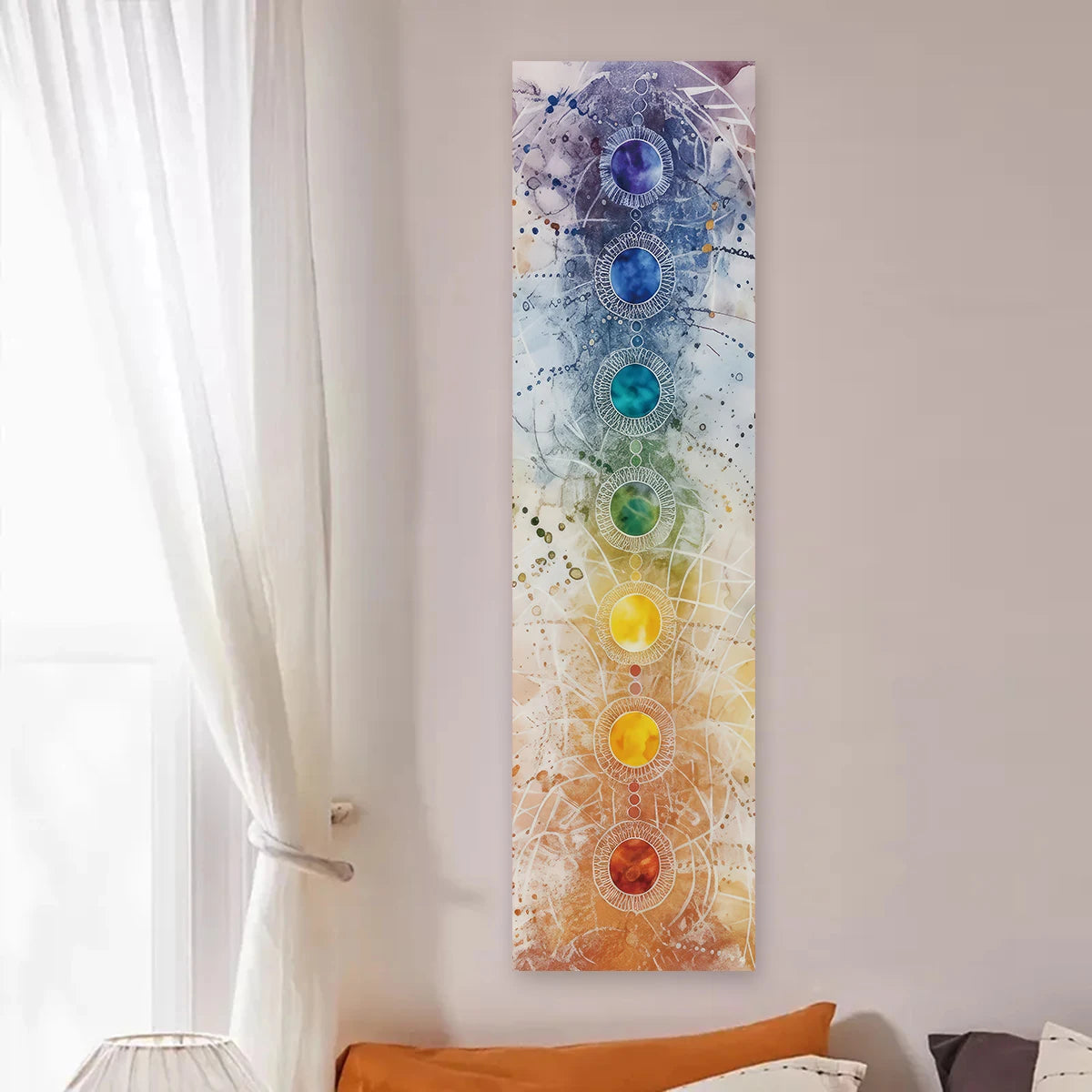 Vertical tapestry featuring a gradient of chakra colors on a white wall.