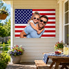 A happy couple smiling while embracing in front of a patriotic American flag backdrop.