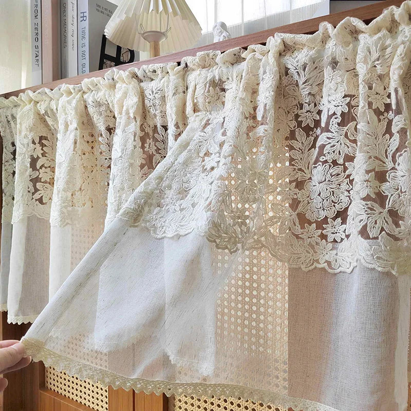 Beige sheer curtain featuring delicate floral embroidery and lace trim.
