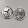Two silver challenge coins featuring a crow and skull design, labeled with text like Now I Have Zero Zilch Nada None and Last