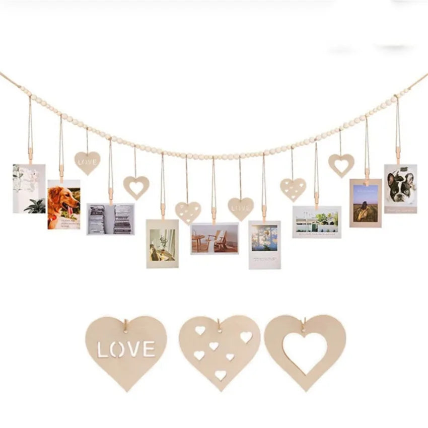 A delicate gold photo display garland featuring heart-shaped photo frames hanging in a line.