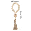 Handmade wood and jute bead garland with a heart pendant and tassel