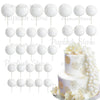 A set of white foam cake toppers, including various sized round and petal shapes, displayed on white sticks.