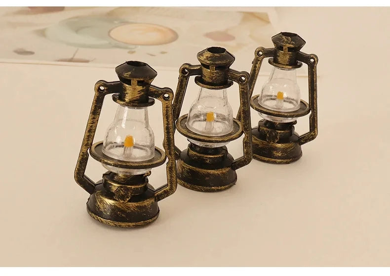 Three vintage ceramic miniature lanterns with glass bulbs and brass frames for dollhouse décor