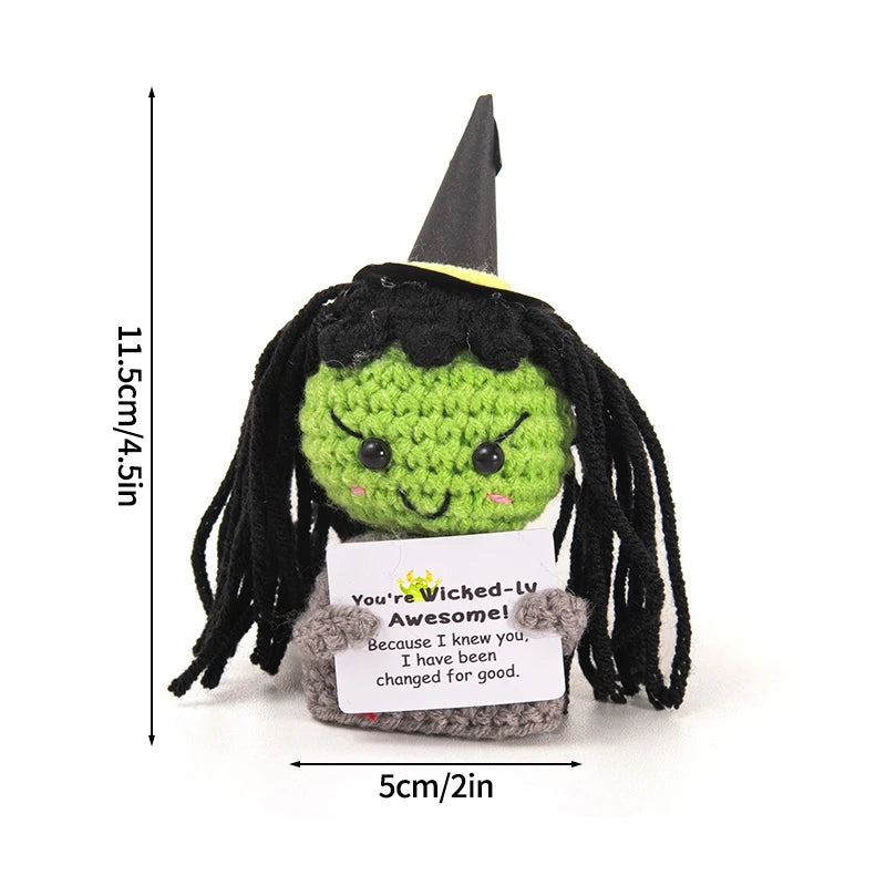 Handmade crochet potato doll with black hair and green body featuring an inspirational slogan pocket