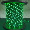 A close-up of a cylindrical string of bright green addressable LED lights.