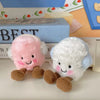 A set of two fluffy marshmallow plush toys, one pink and one white, with brown feet, displayed next to a box.