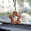 A sparkling, rose gold rhinestone star charm hanging from a silver chain.
