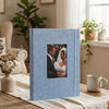 A light blue linen photo album with a black and white photograph of a couple inside.