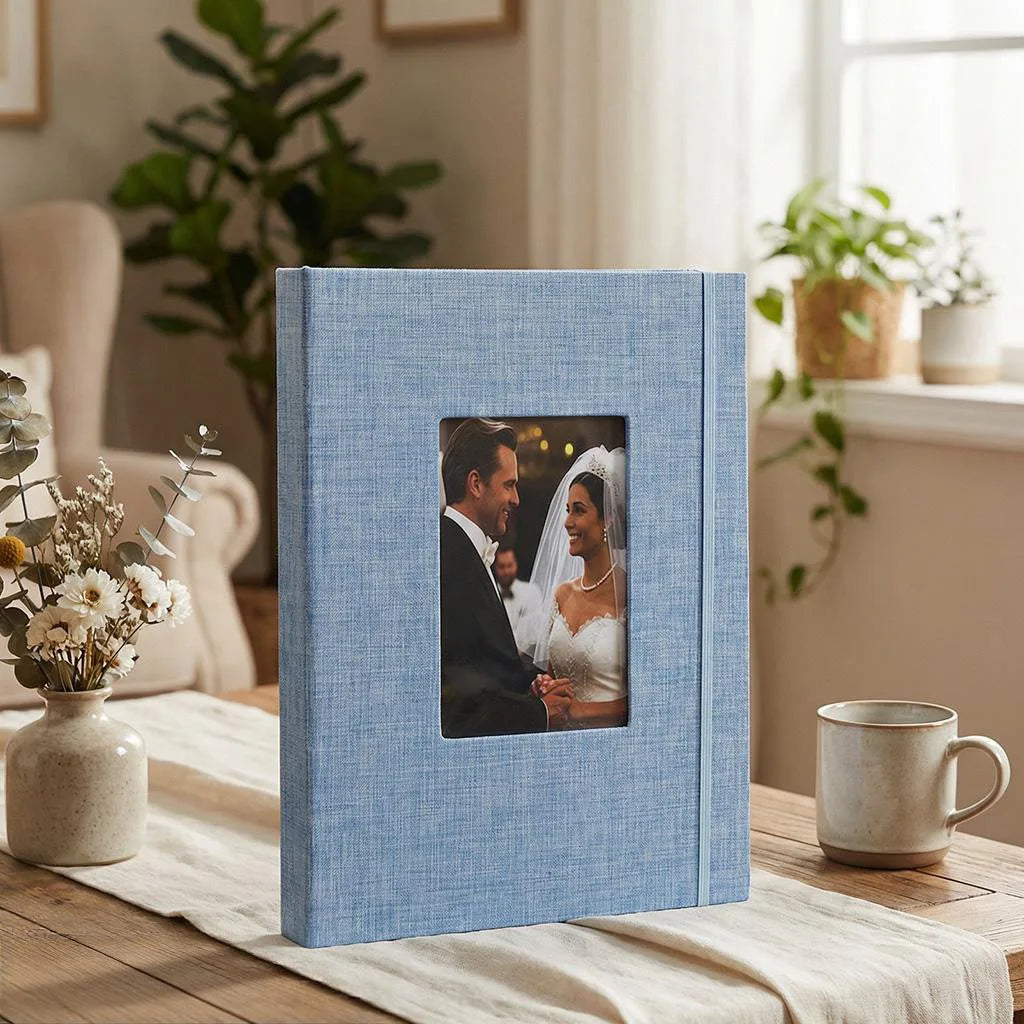 A light blue linen photo album with a black and white photograph of a couple inside.