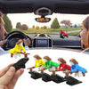A set of witch and wizard flying carriage dashboard decor figures in various colors are shown being held by a hand.