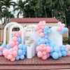 A large arrangement of pastel pink and blue balloons decorated in a horseshoe shape for party or wedding use.
