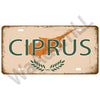 A vintage metal tin sign featuring the word CIPRUS and a silhouette of the island, set against a rustic background.