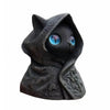 A dark, textured statue of a cat wearing a hood with glowing blue eyes.