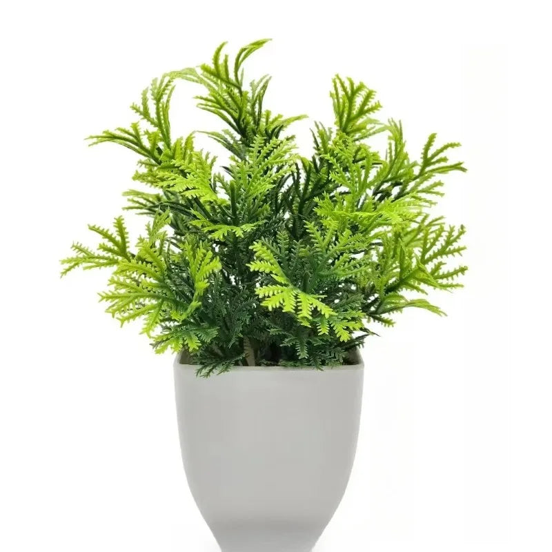 Lebendiges Kunstbonsai mit leuchtend grünem Laub in weißem Topf.