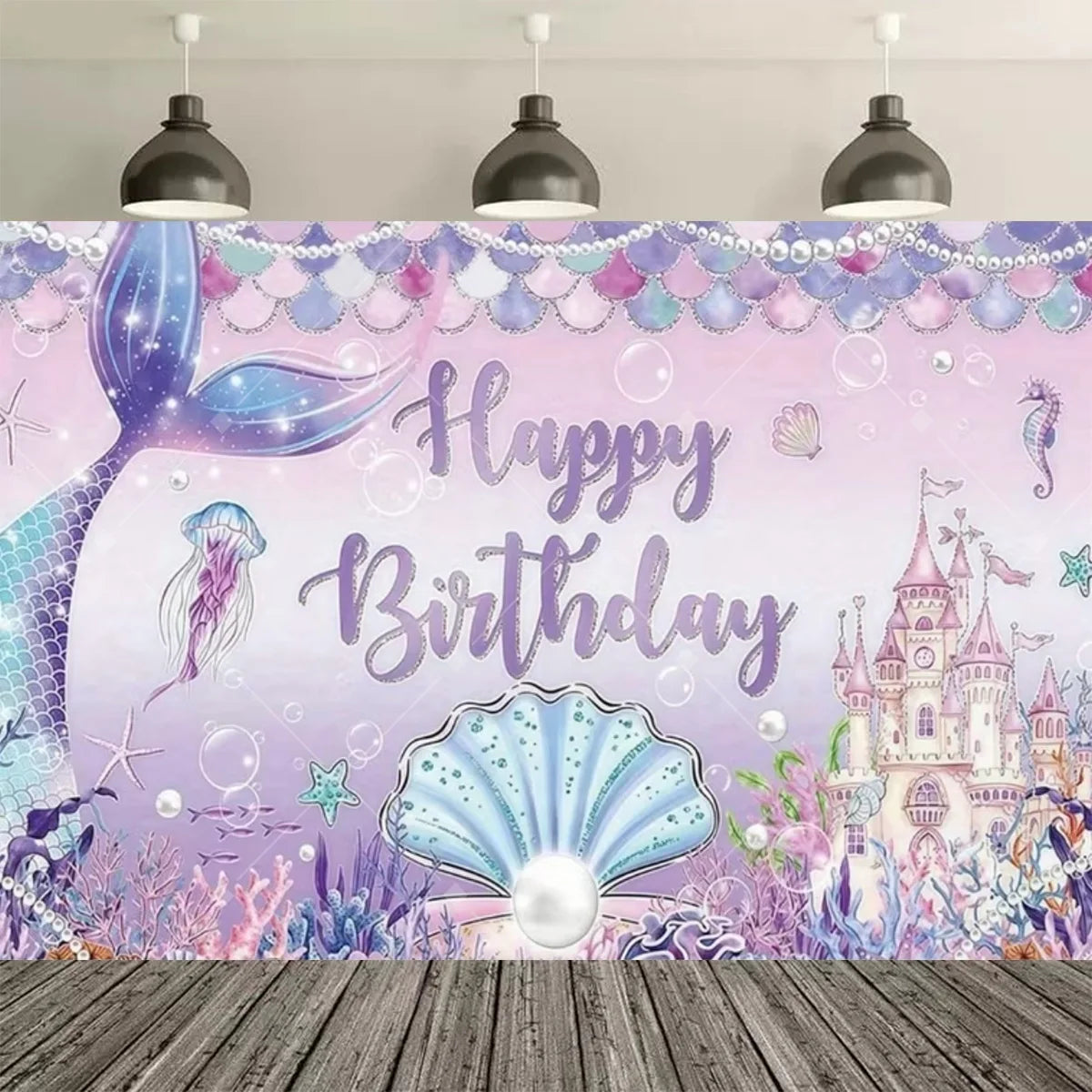 A pink and purple mermaid tail birthday backdrop featuring a large tail, seashells, and a castle illustration.
