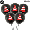 Five black foil balloons shaped like construction trucks with red and white cones for birthday party decor
