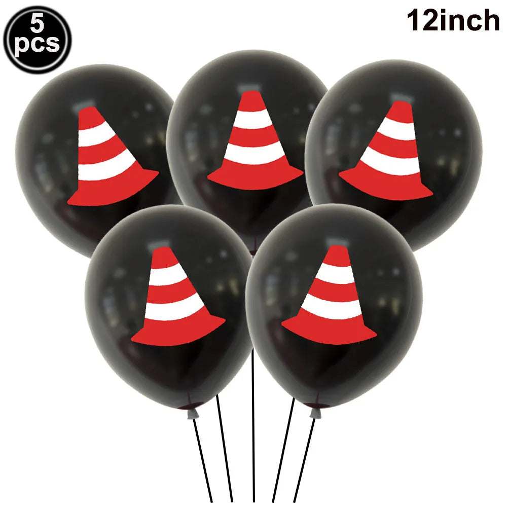 Five black foil balloons shaped like construction trucks with red and white cones for birthday party decor