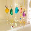 A set of hanging crystal decor featuring various colored agate stones and sun motifs.