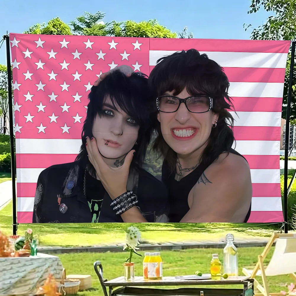 A photo of Jake Webber and Johnnie Guilbert tapestry wall hanging displayed in an outdoor setting.
