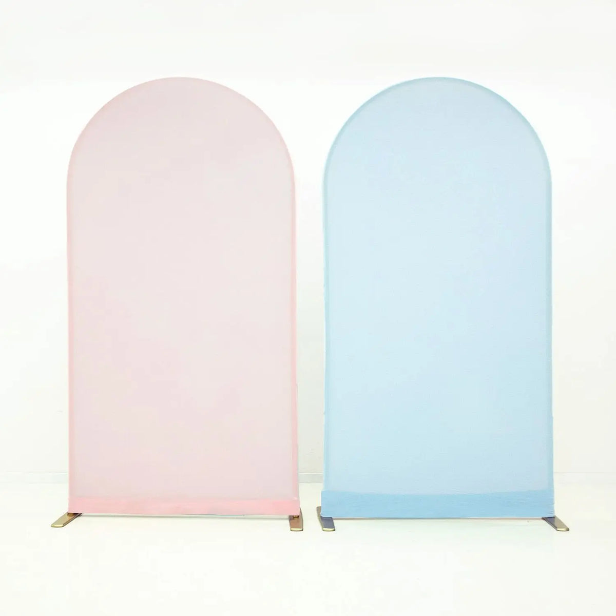 A pair of light pink and light blue stretchable arch backdrop covers displayed against a white background.