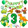 A colorful dinosaur party decoration kit featuring foil balloons, a banner, and a cake topper.