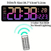 A digital wall clock displaying 20:38, temperature, and day, with a remote control visible below it.