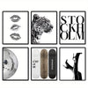 A collection of nine black and white abstract canvas prints featuring leopard faces, a tiger head, and a silver mosaic textur