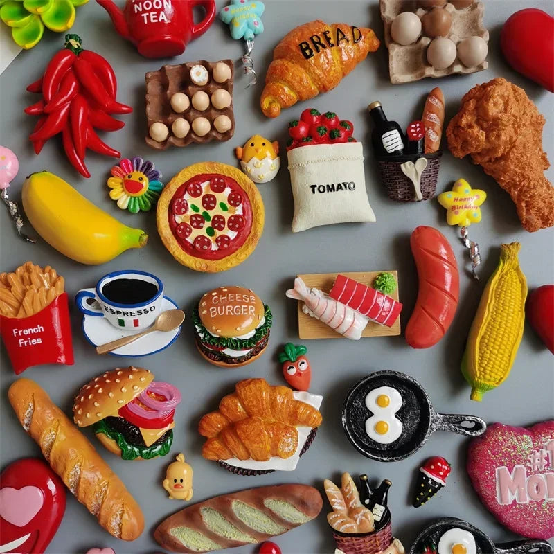 A collection of colorful food-shaped fridge magnets including fruits, vegetables, and baked goods.
