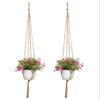 Handmade macrame plant hanger with a woven rope and a small potted pink flower basket hanging from a macrame cord.