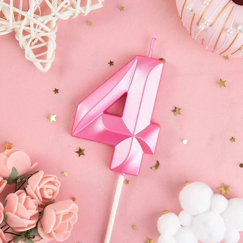 Pink number four candle with glitter on a pink background surrounded by gold stars and pink roses