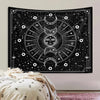 Black tapestry wall hanging featuring a psychedelic sun and moon mandala design with intricate geometric patterns.