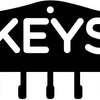 Black decorative metal wall-mounted key holder with seven hooks.