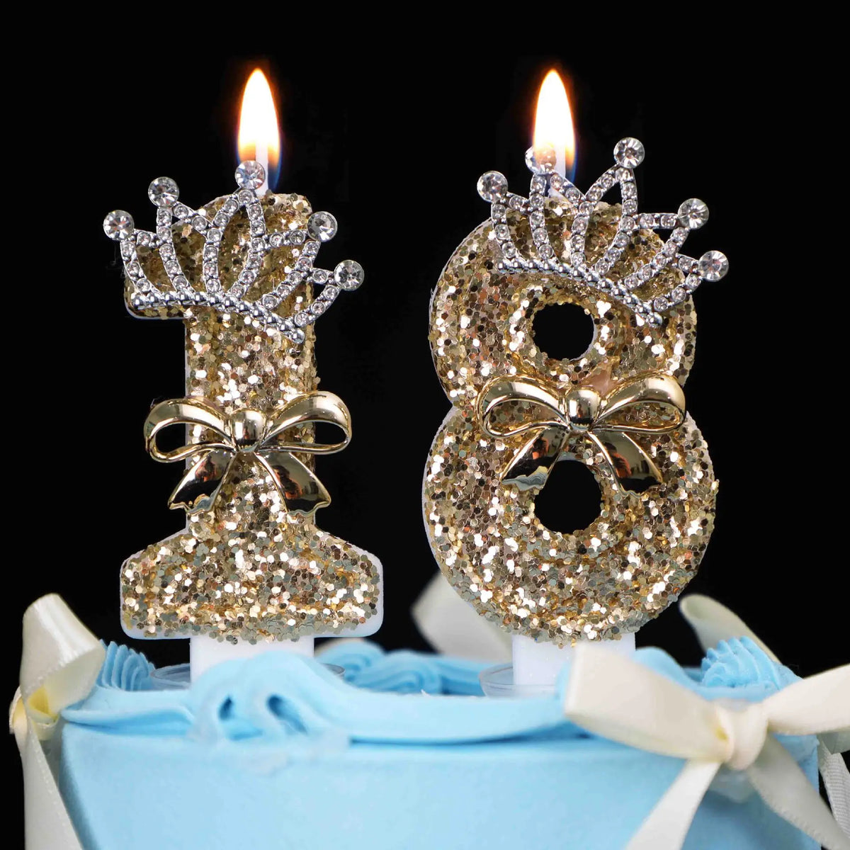 Gold glitter number cake topper candles with rhinestone bow on a light blue cake.