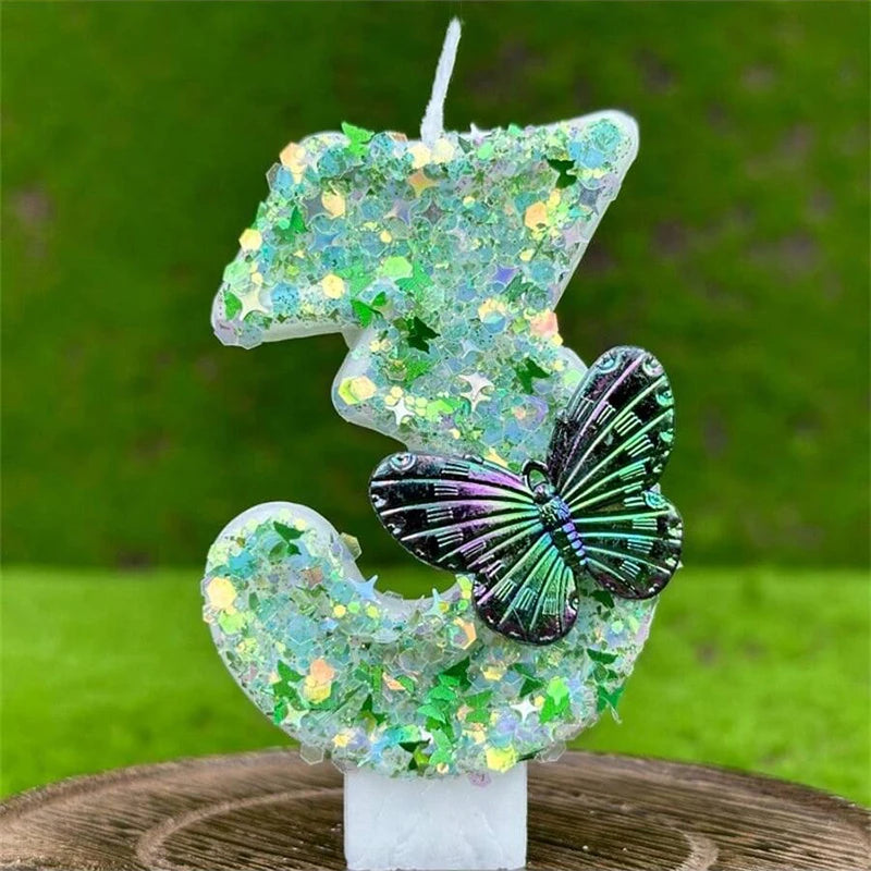 A glittery green sequin number candle shaped like a butterfly for a birthday cake decoration.