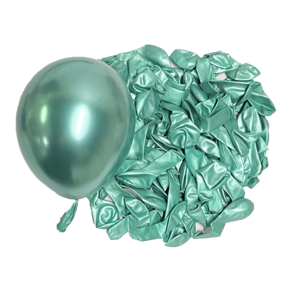 A glossy mint green latex balloon next to a pile of crumpled metallic teal foil balloons.